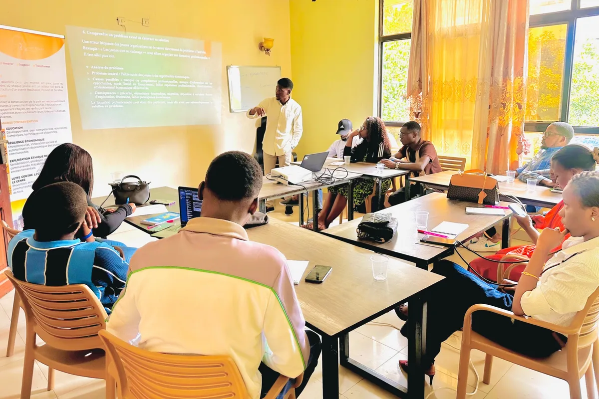 Participants with laptops and notebooks at the Vijana Campus in Goma during a facilitated training session
