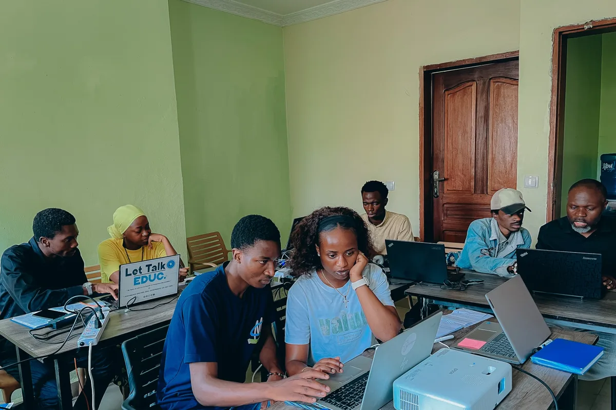 Two participants collaborate closely at a laptop during hands-on learning at the Vijana Campus in Goma