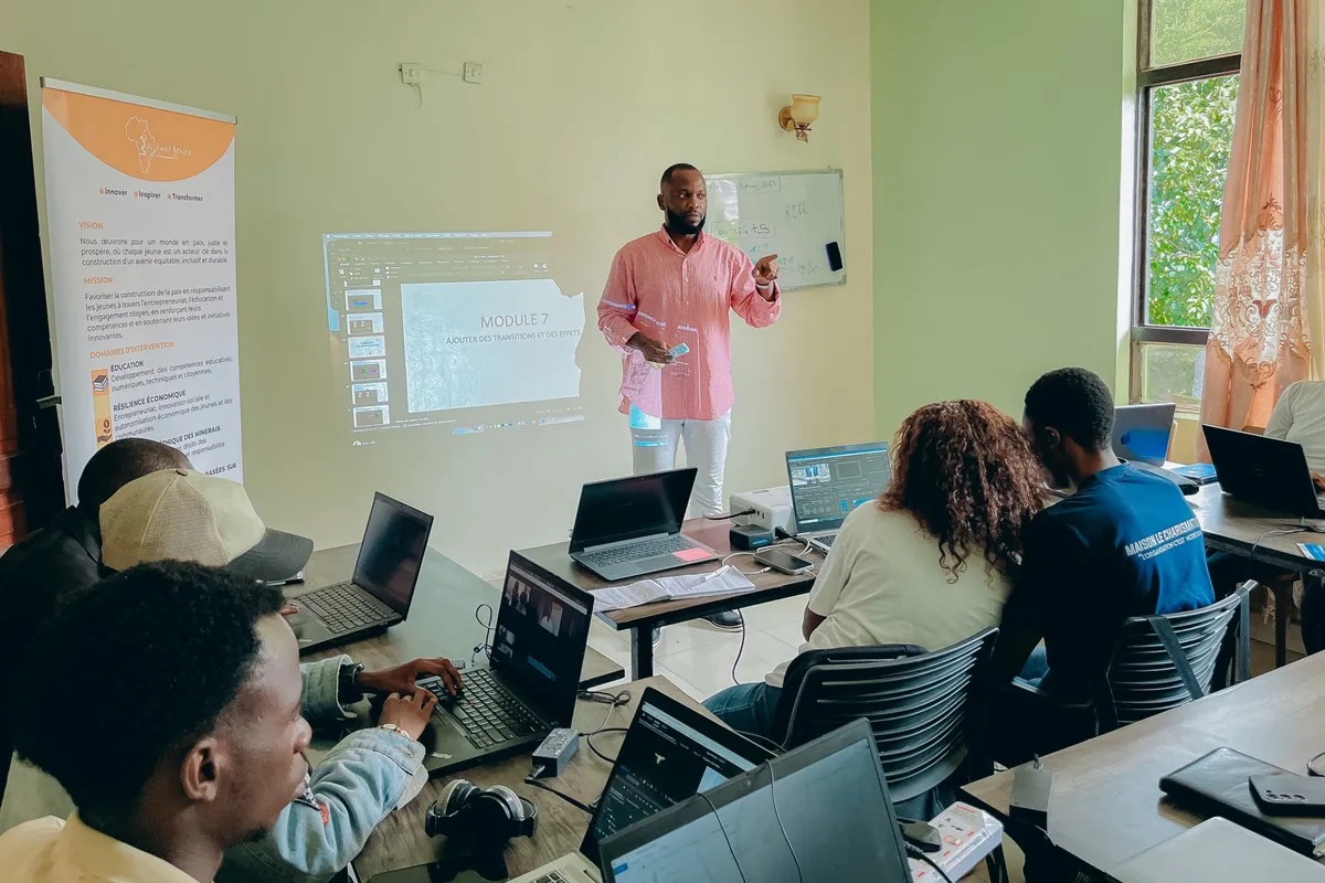 Vijana Africa staff presenting at a training workshop with laptops